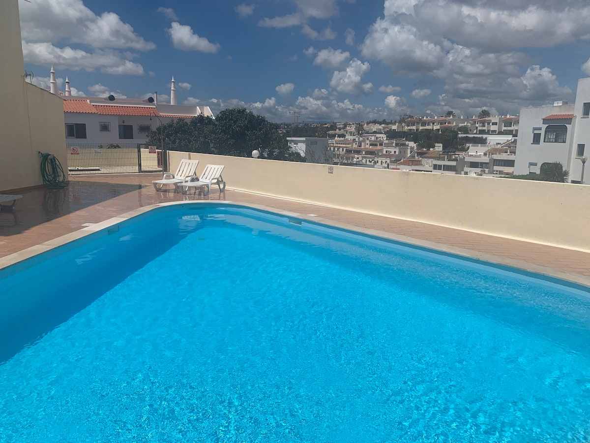Sunny pool terrace and surrounding views